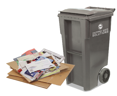 Paper and carboard next to a recycling cart
