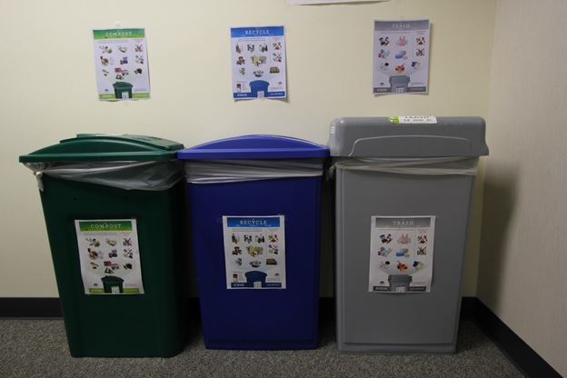 A indoor recycling station with three different bins
